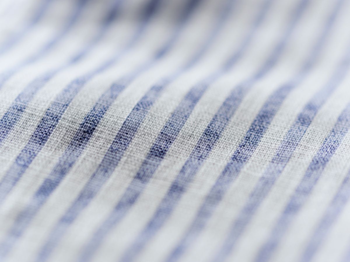 Blue and white striped cotton shirting fabric close-up